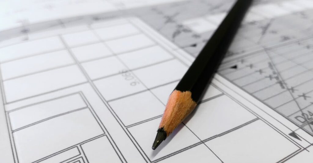 Detailed image of a black pencil resting on architectural blueprints, ideal for design and planning themes.